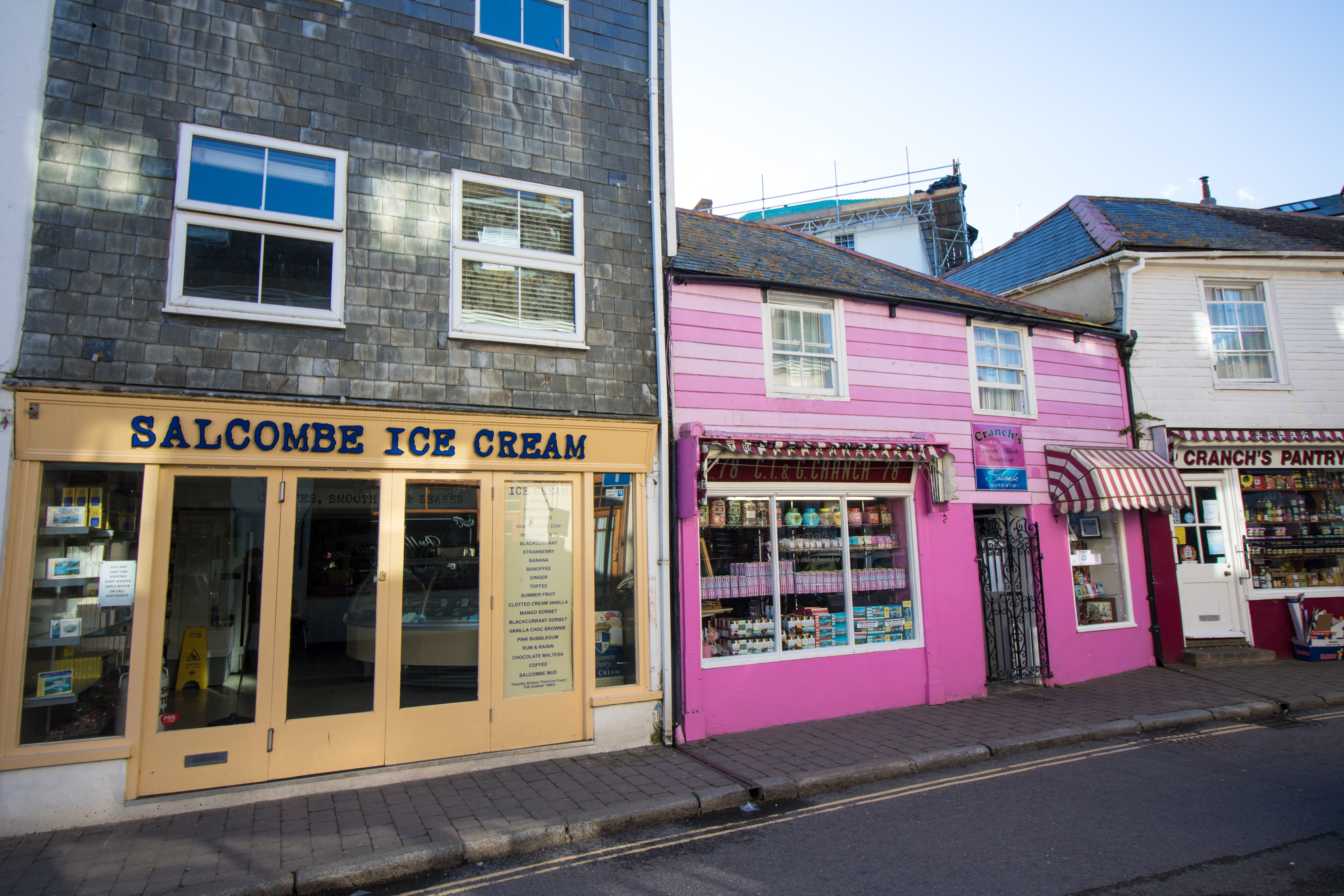 Colourful shop fronts. Salcombe Ice Cream yellow shop. Pink sweet shop. Cranch's Devon's oldest sweetshop. British street in seaside town. 17 Beautiful Places to Visit in Devon for a Great Day Out. Devon England. Devon UK. Things to do in Devon. Places to see in Devon. What to see in Devon. Things to see in Devon. What to do in Devon. Devon attractions. Devon top attractions. Devon travel blog. Devon travel guide. The English Riviera. Exeter. Plymouth. Dartmouth. Dartmoor National Park. Exmoor National Park. Salcombe. Clovelly. Totnes. Appledore. Watermouth. Croyde. Woolacombe. Dartmouth. Ilfracombe. Beer. Burgh Island. Lundy Island. Click through to read more...