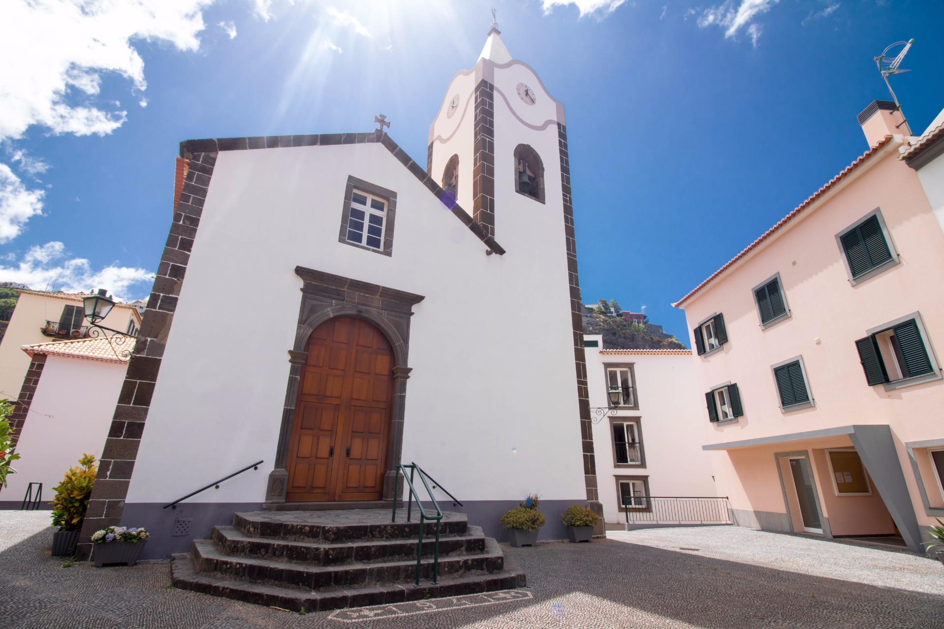 small-white-european-church-in-ponta-do-sol-village-against-blue-skies
