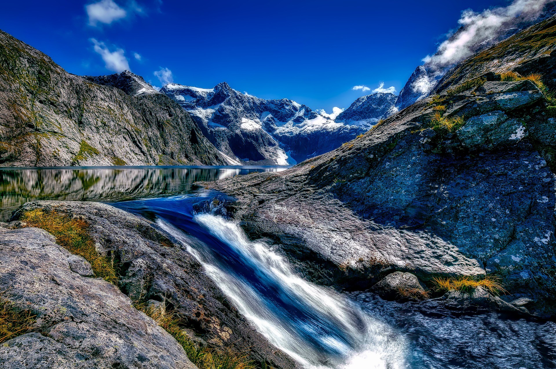 water-rushing-waterfall-through-a-glacier-in-the-mountains-in-fjordland