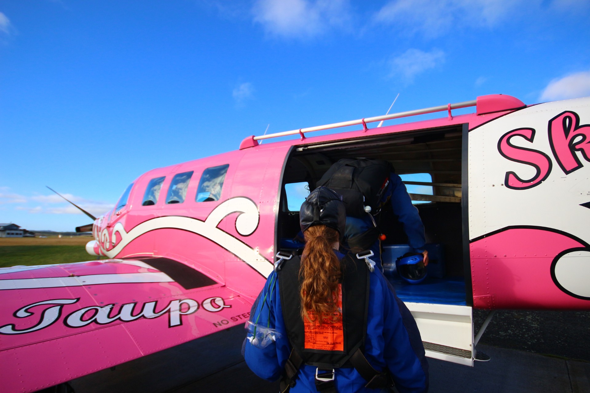 Pink airplane pink plane blue skies curly hair Skydive Taupo The Best Skydiving in New Zealand