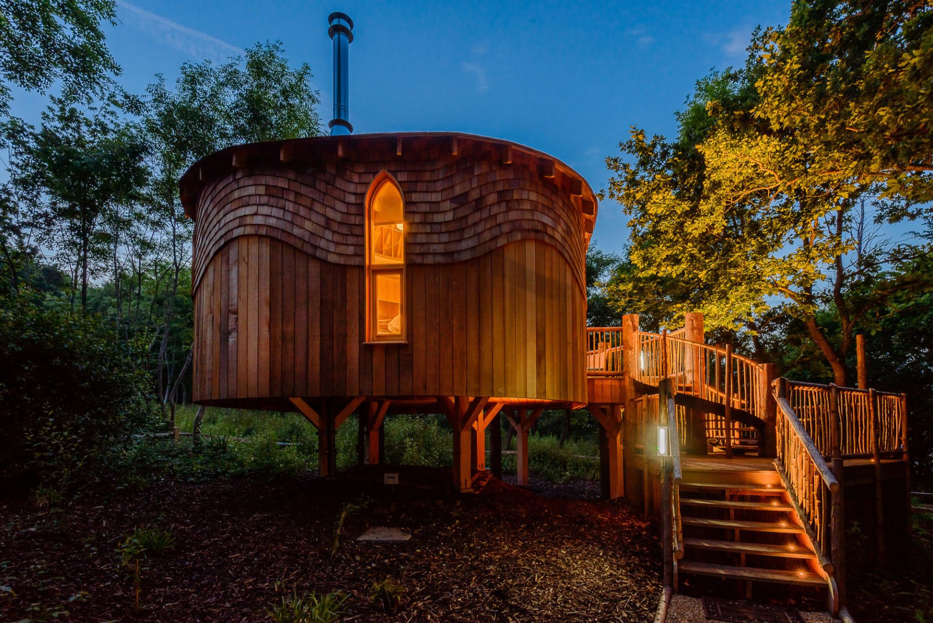 low-round-treehouse-in-woods-lit-up-at-night-woodside-bay-wootton-bridge-isle-of-wight