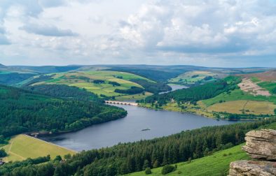 picturesque-view-of-a-reservoir-bridge-and-rolling-green-hills-at-bamford-edge-in-the-peak-district