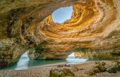 boat-sitting-on-sand-in-sandy-cavern-at-benagil-cave-portugal-in-the-algarve