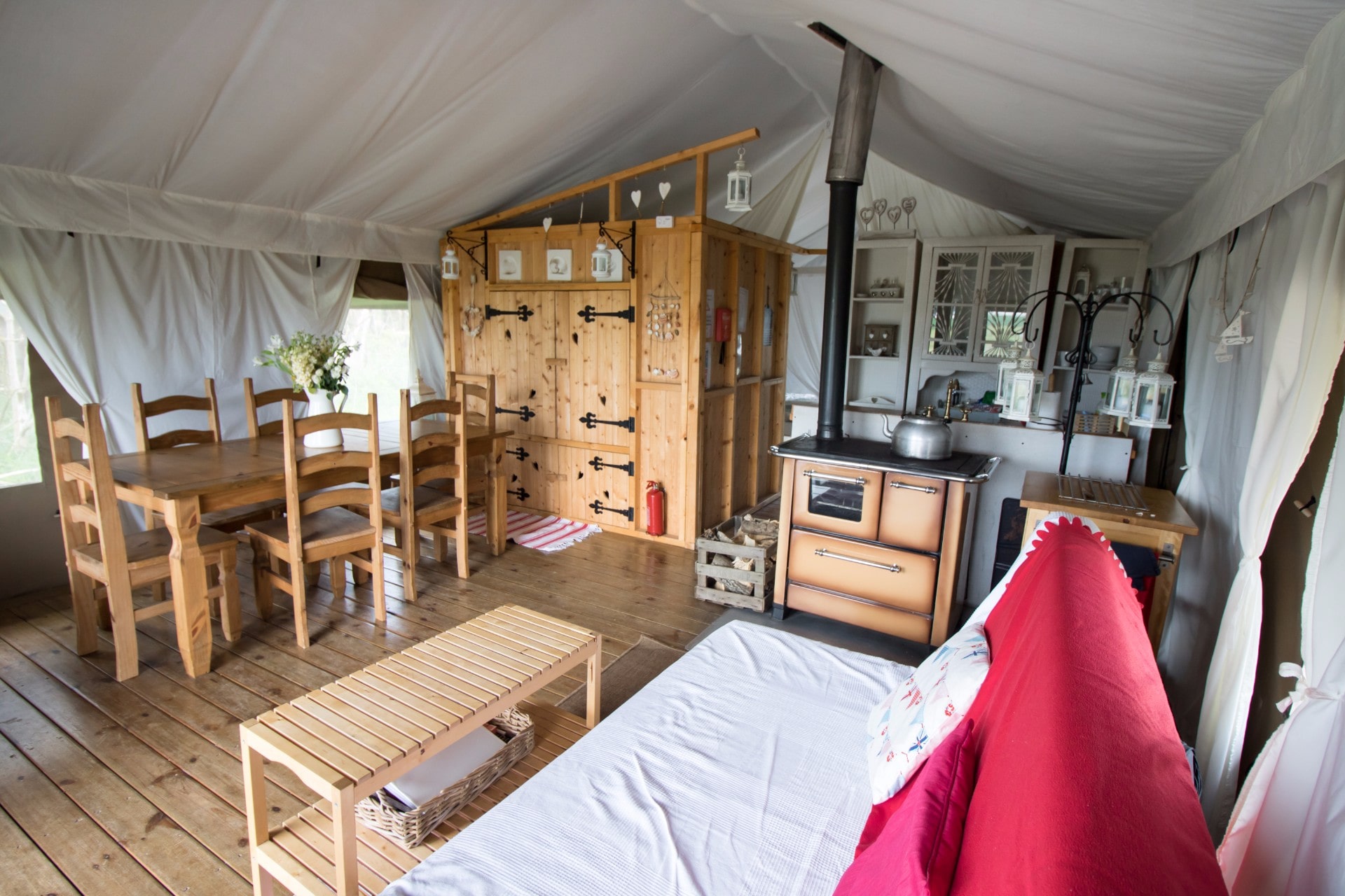 inside-a-safari-tent-glamping-site-with-kitchen-bed-table-and-sofa-harvest-moon-holidays-scotland-unusual-romantic-weekend-breaks-uk