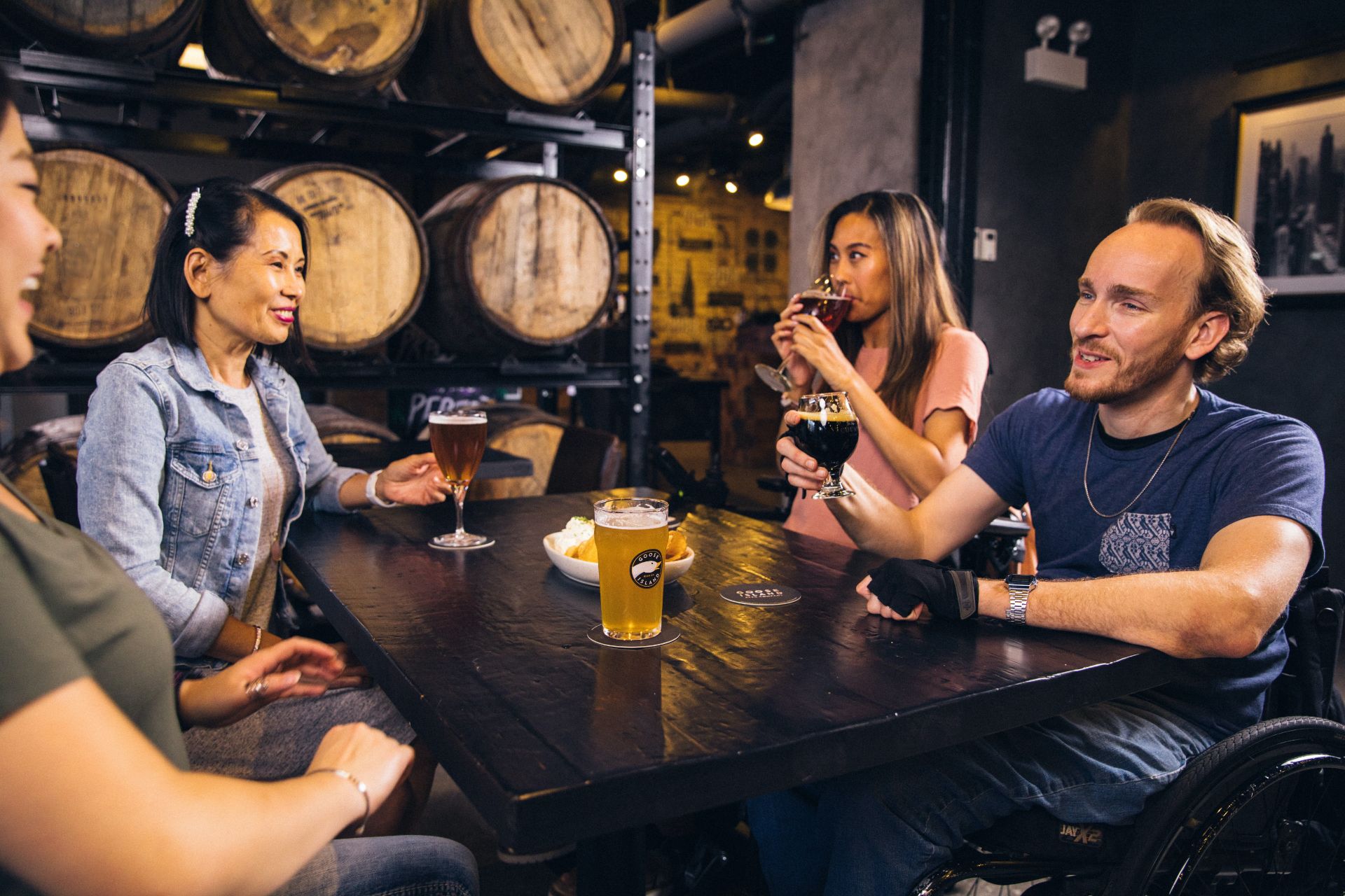 group-of-friends-enjoying-drinks-over-a-table-at-a-brewery