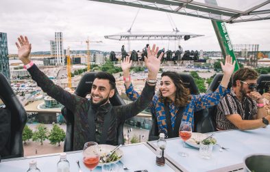 man-and-woman-with-their-arms-in-the-air-eating-dinner-in-the-sky-in-a-city-at-london-in-the-sky-quirky-places-to-eat-in-london