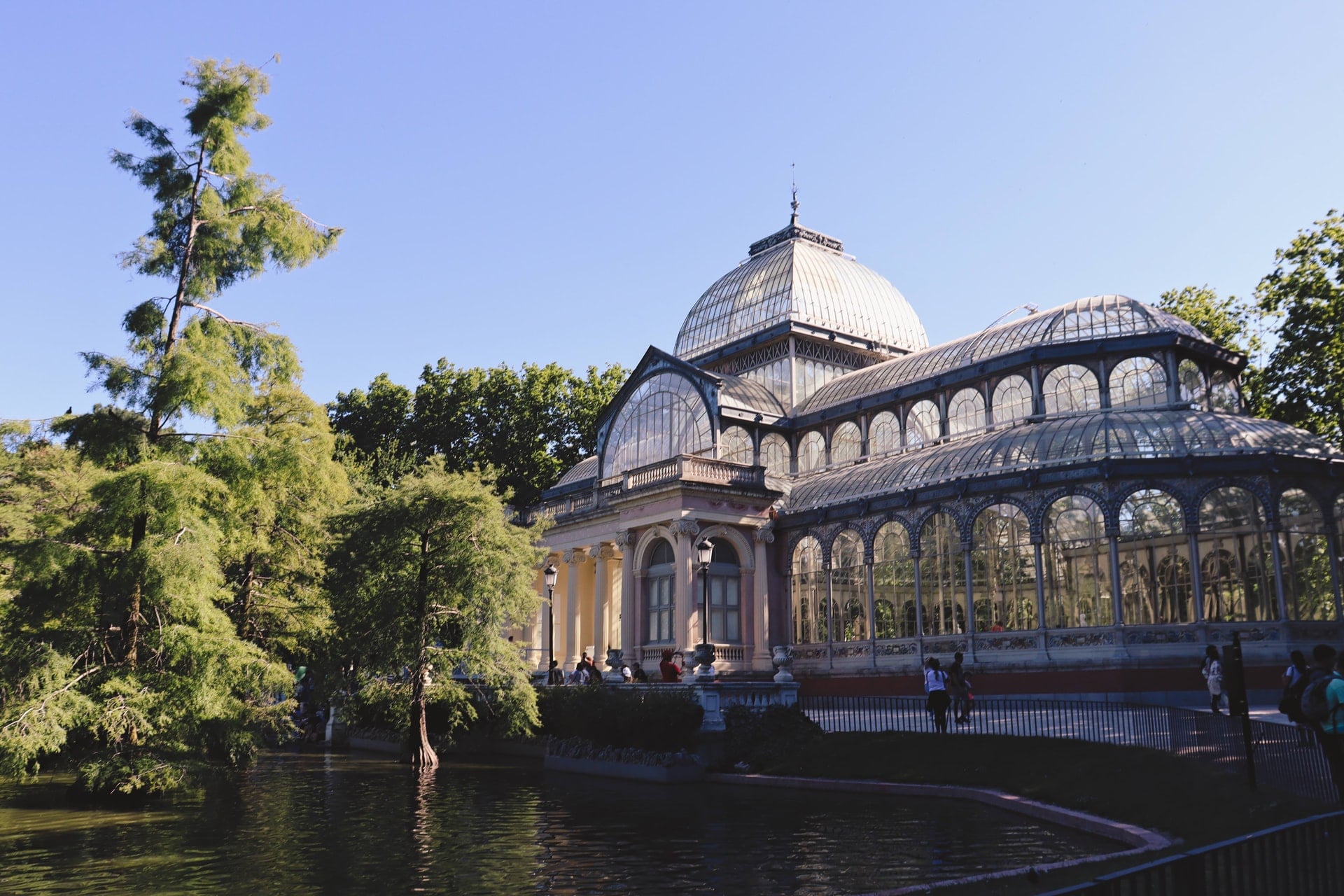glasshouse-in-park-on-a-sunny-day-by-a-pond-and-trees-in-el-retiro-park-madrid