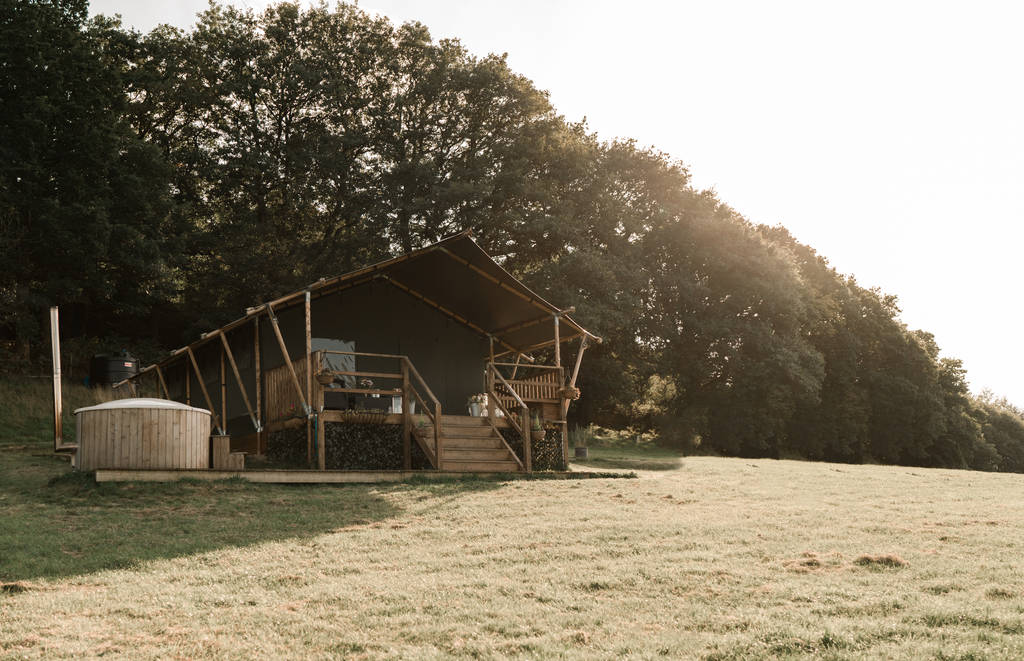 safari-tent-and-hot-tub-in-field-in-front-of-trees-two-valleys-retreat-safari-tent-presteigne-powys