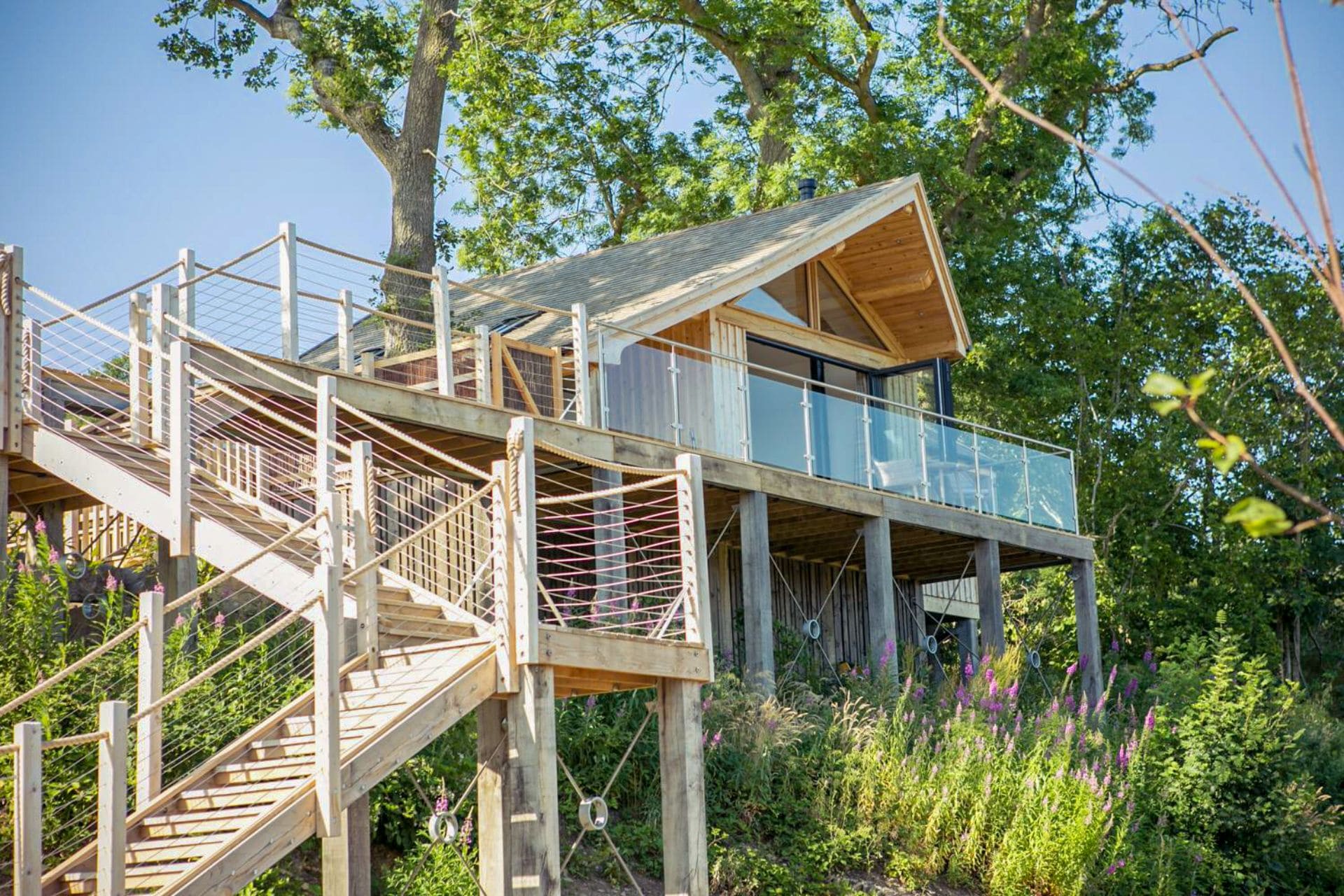 steps-leading-up-to-beach-inspired-treehouse-found-amongst-trees-oaklands-treehouse-welshpool-powys-wales-glamping-with-hot-tub-wales
