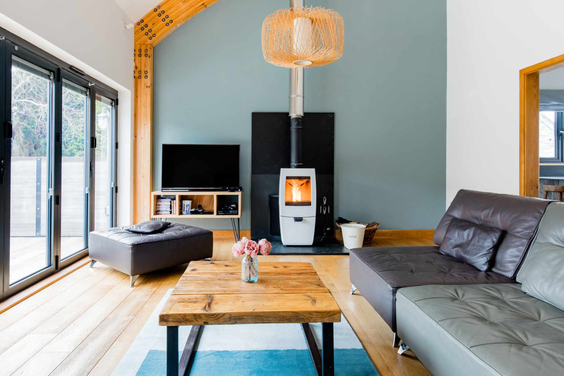cosy-living-room-with-sofas-and-log-burner-in-barn-holiday-home-in-bude