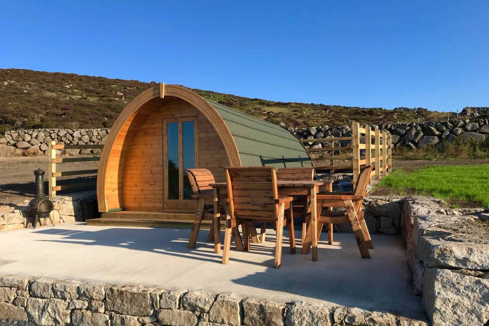 glamping-pod-on-decking-with-table-and-chairs-on-hillside-carrick-little-glamping