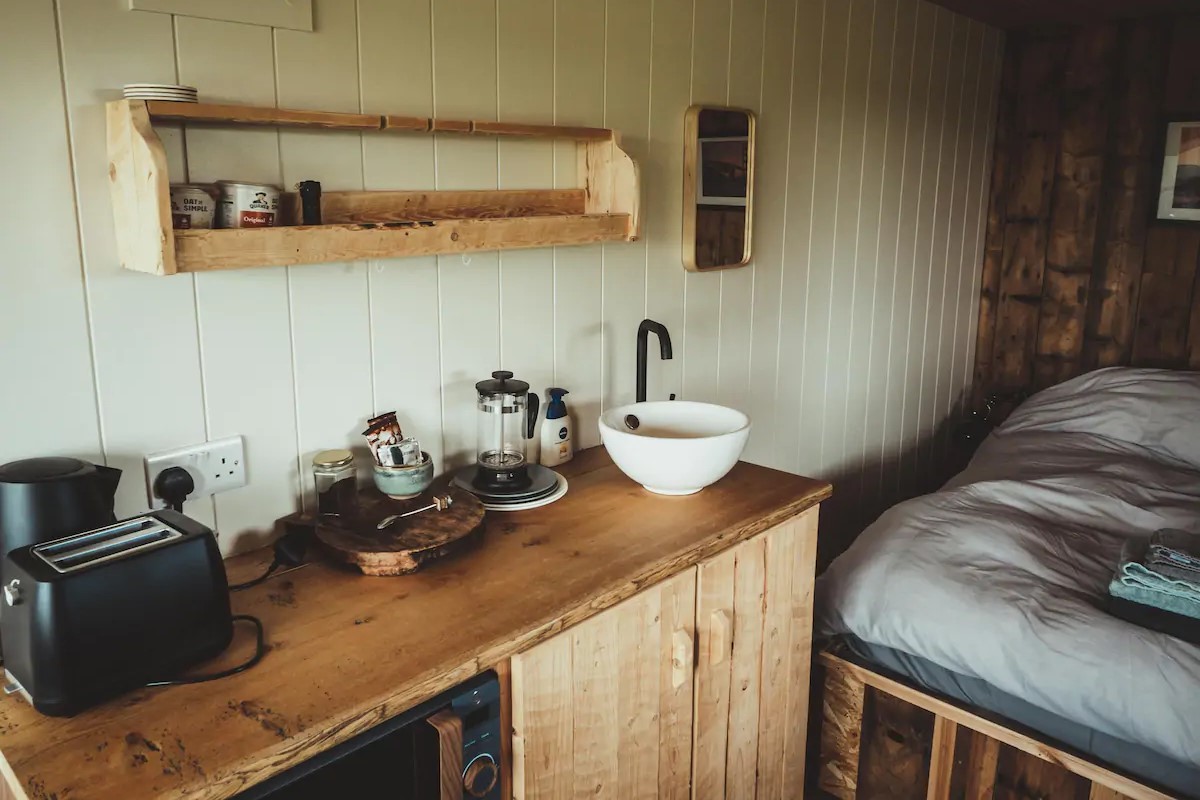 inside-rustic-cabin-kitchen-and-bedroom-at-the-surf-shack-causeway-coast-ballycastle