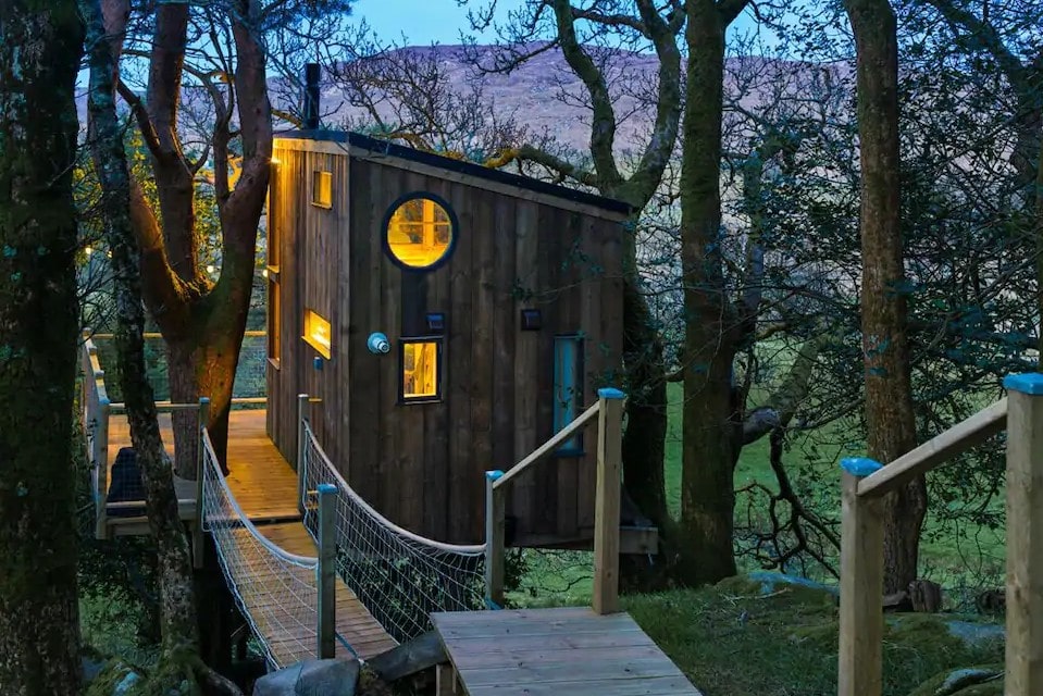 the-birdbox-treehouse-in-the-trees-lit-up-at-night-glamping-donegal