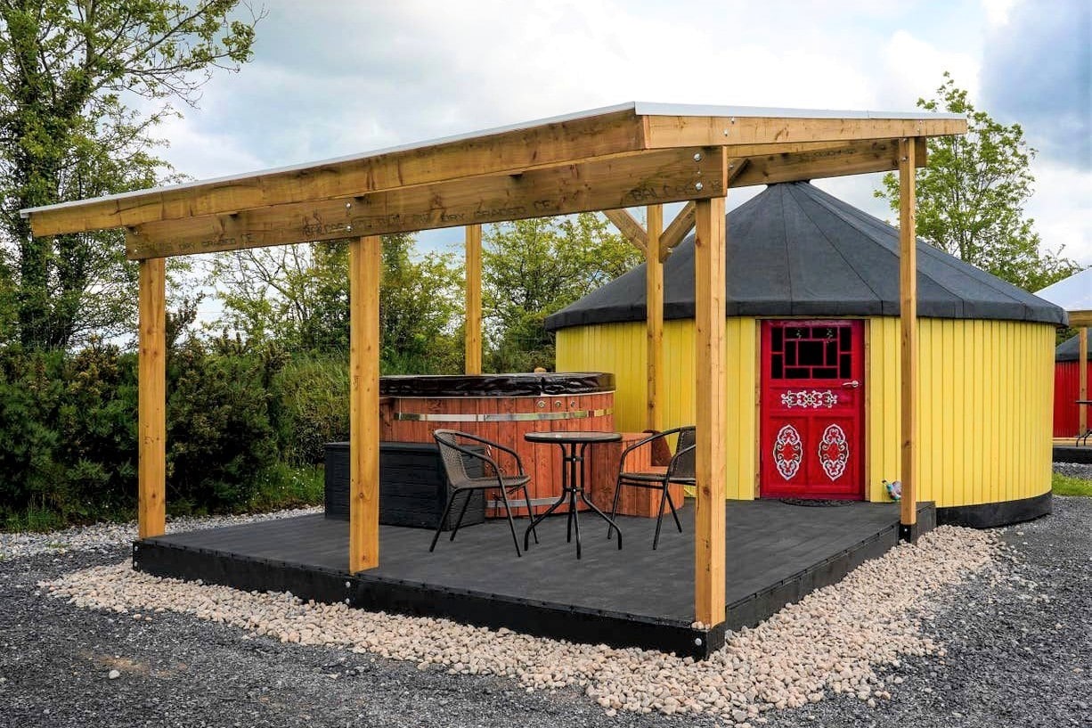 yellow-yurt-with-red-door-and-outdoor-hot-tub-yurty-ahern