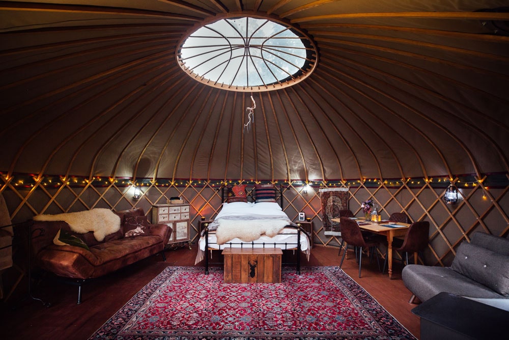 bedroom-and-living-area-of-wildwood-at-the-yurt-sanctuary-somerset-glamping