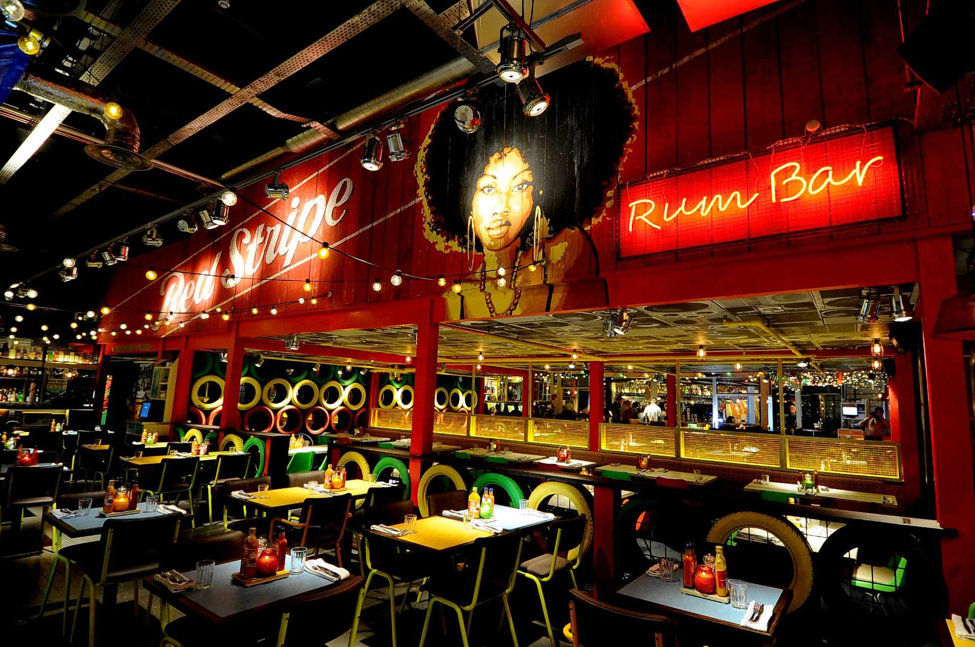 bright-red-rum-bar-in-dark-with-restaurant-seating-at-turtle-bay