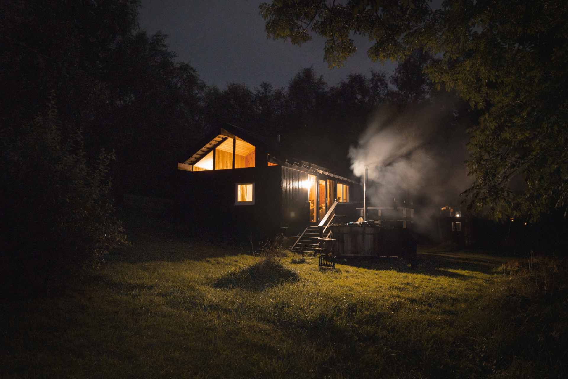 fyne-cabin-with-hot-tub-in-field-lit-up-at-night