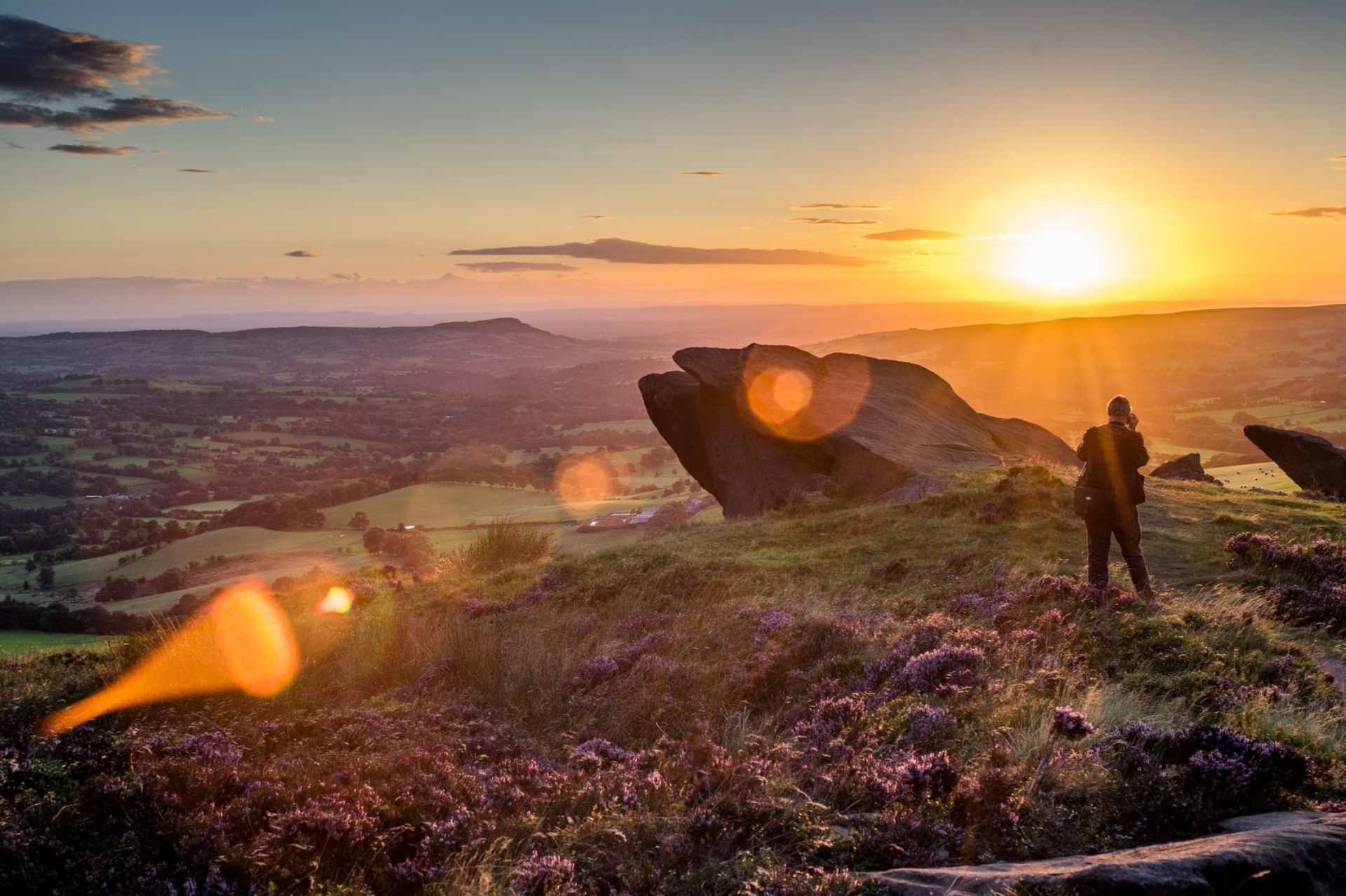 man-standing-on-top-of-hill-by-big-rock-at-sunset-the-roaches-and-luds-church