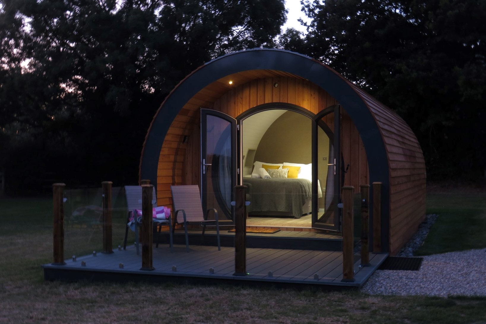 millview-meadow-glamping-pod-lit-up-at-night-in-field