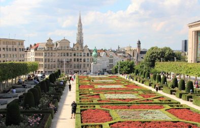 people-walking-in-park-by-flowers-in-daytime-with-historic-buildings-in-background-2-days-in-brussels-itinerary