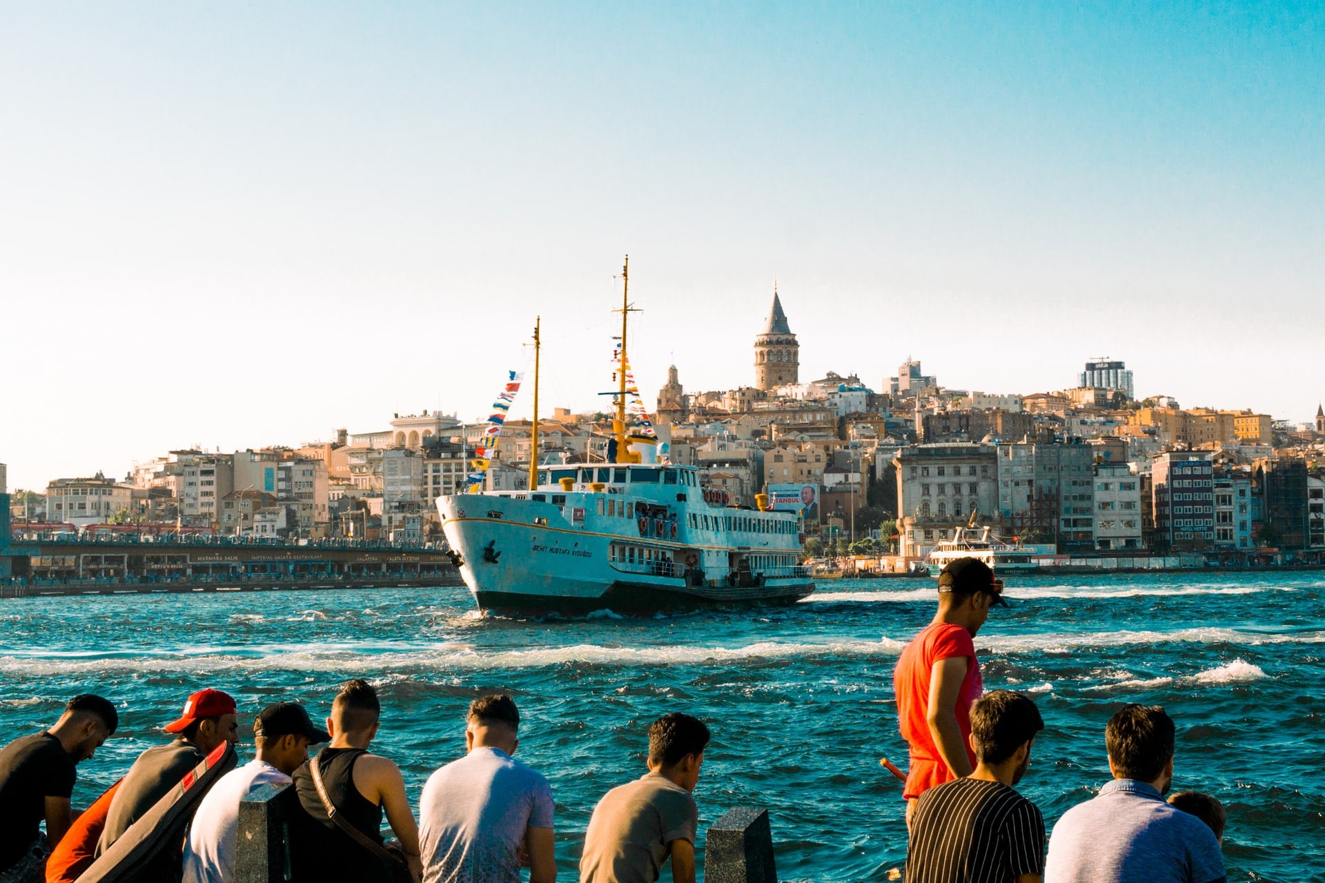 people-watching-white-ship-on-water-travelling-away-from-istanbul