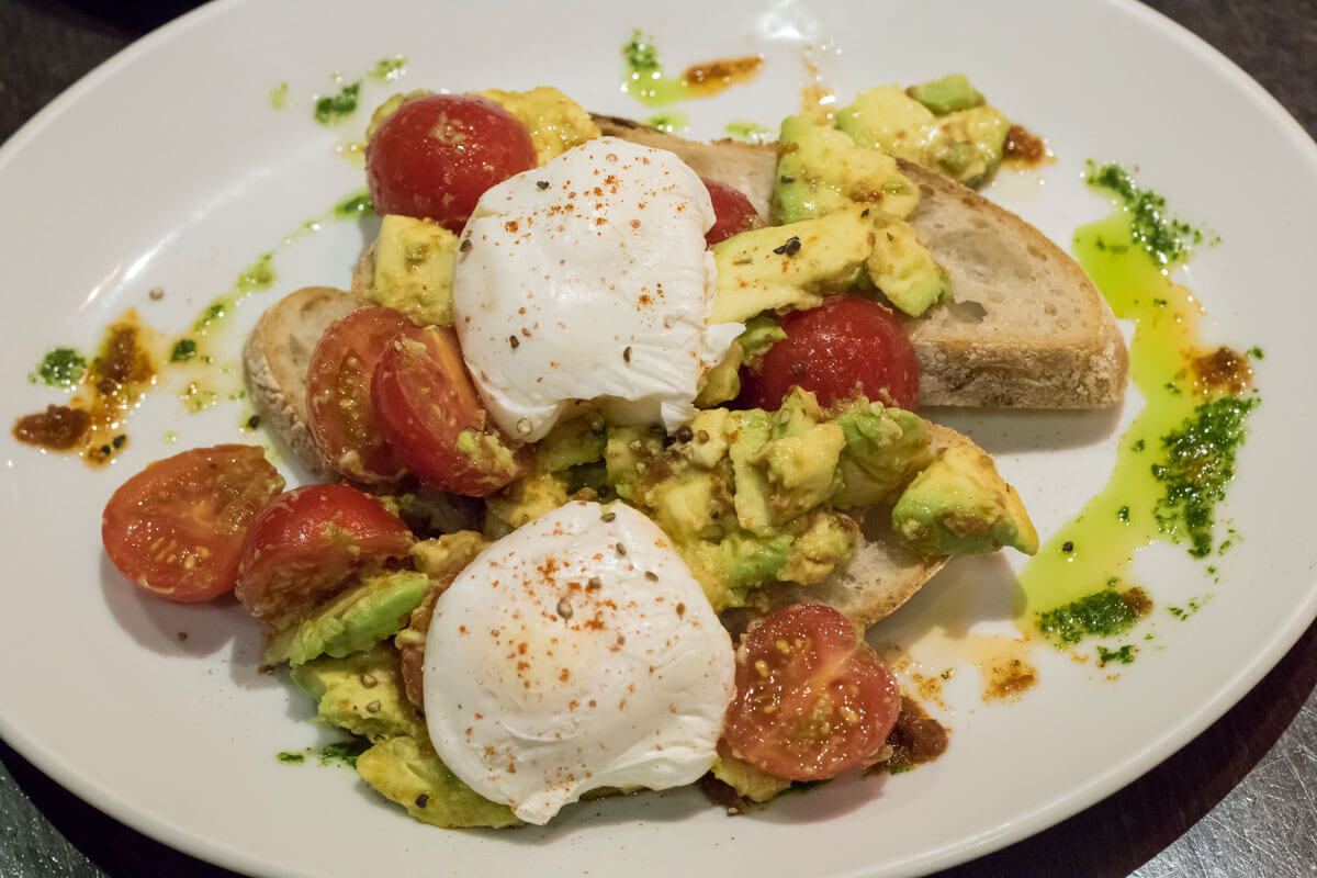 poached-egg-avocado-and-tomatoes-on-sourdough-toast-at-marcos-kitchen
