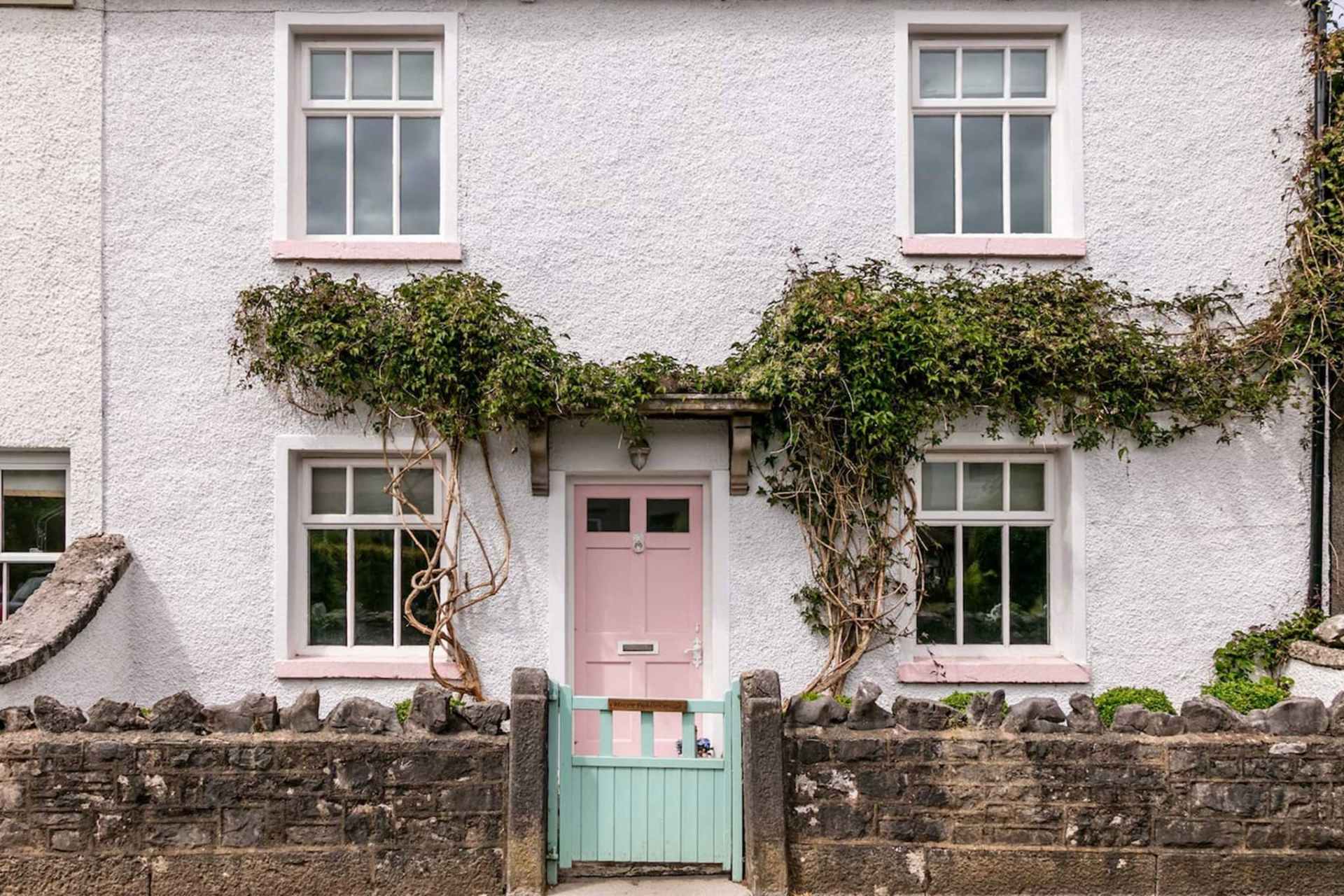 quaint-white-country-cottage-the-nest-in-cartmel-with-pink-door-and-teal-gate