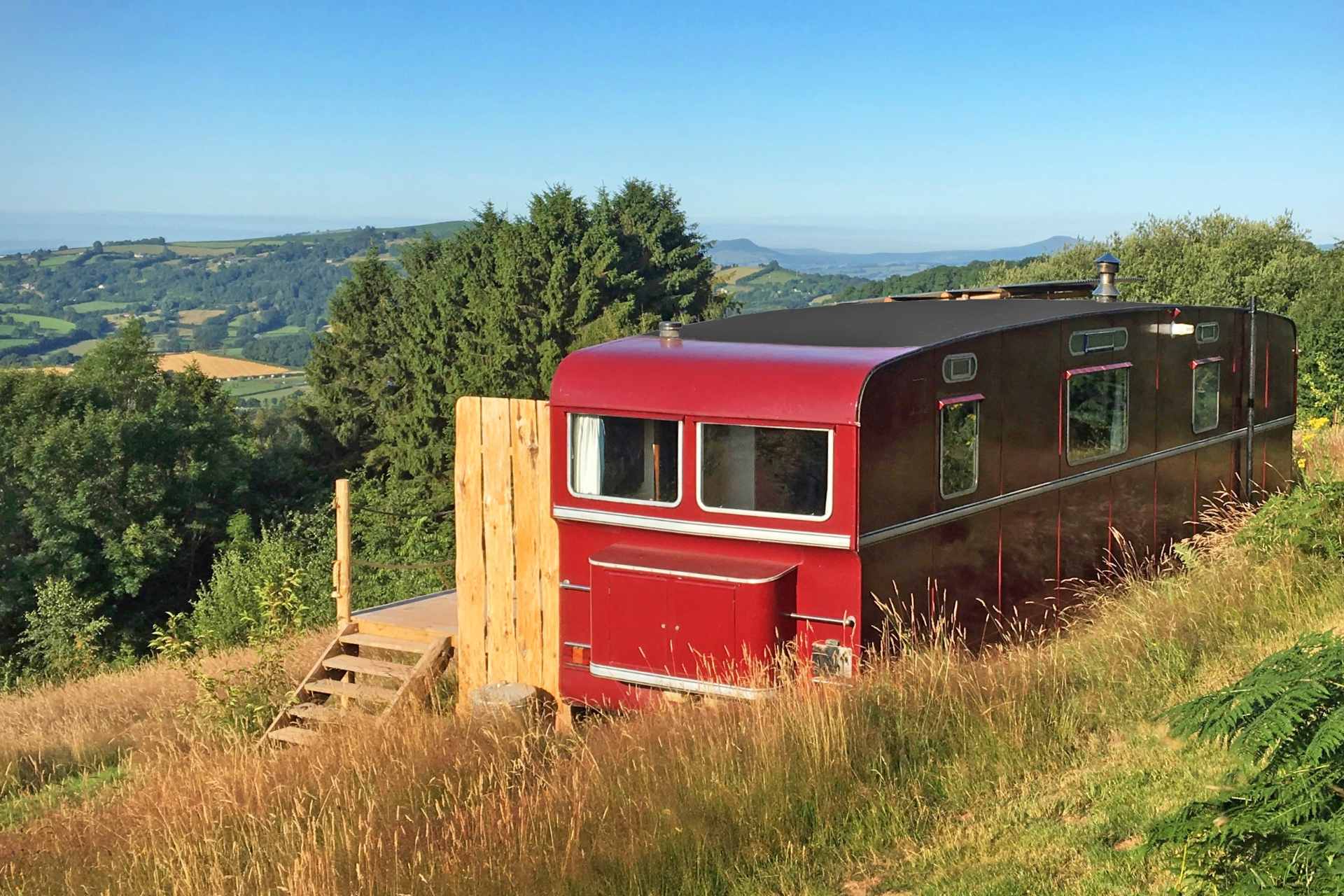 red-wagon-above-the-world-accommodation-on-hill-overlooking-countryside-views