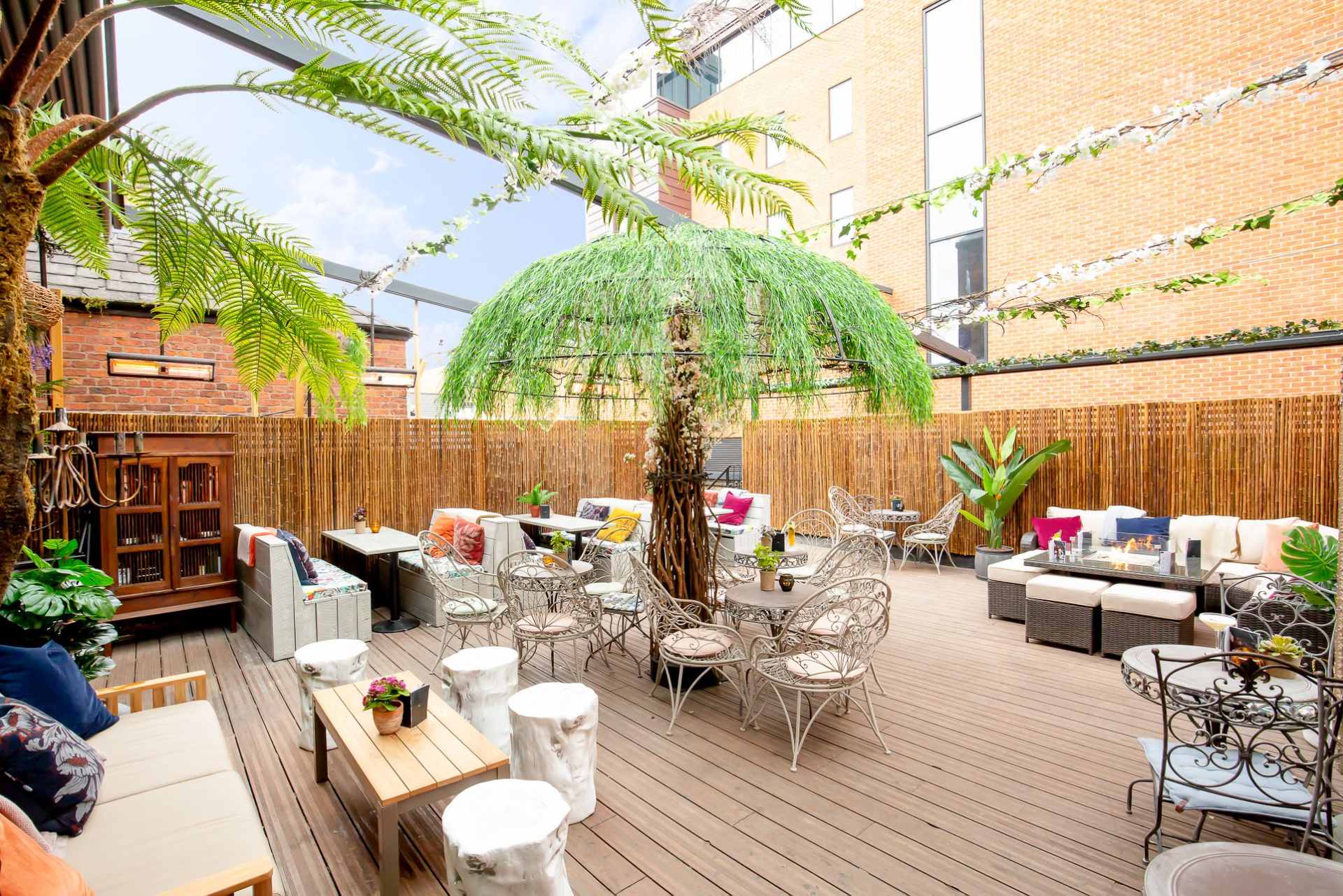 roof-terrace-with-tables-and-fake-palm-trees-at-red-door-bar-date-ideas-liverpool
