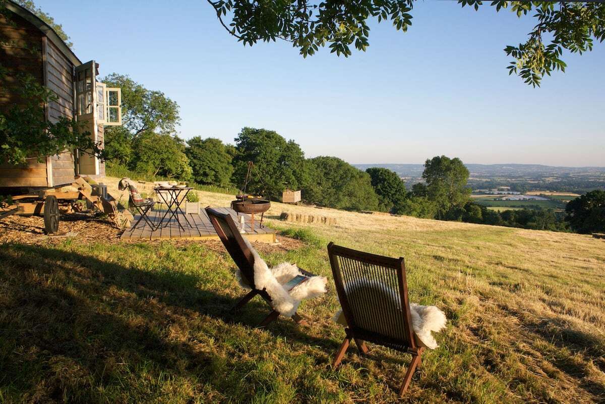 seating-outside-tilbury-farm-shepherds-hut-overlooking-countryside-views