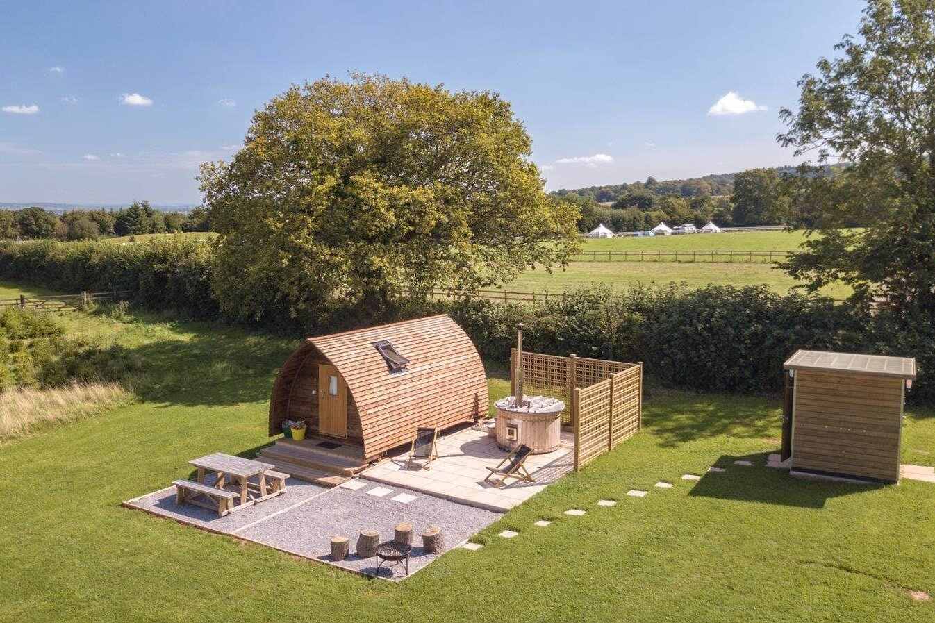secret-valley-wigwam-pod-on-decking-with-hot-tub-in-field-somerset-glamping