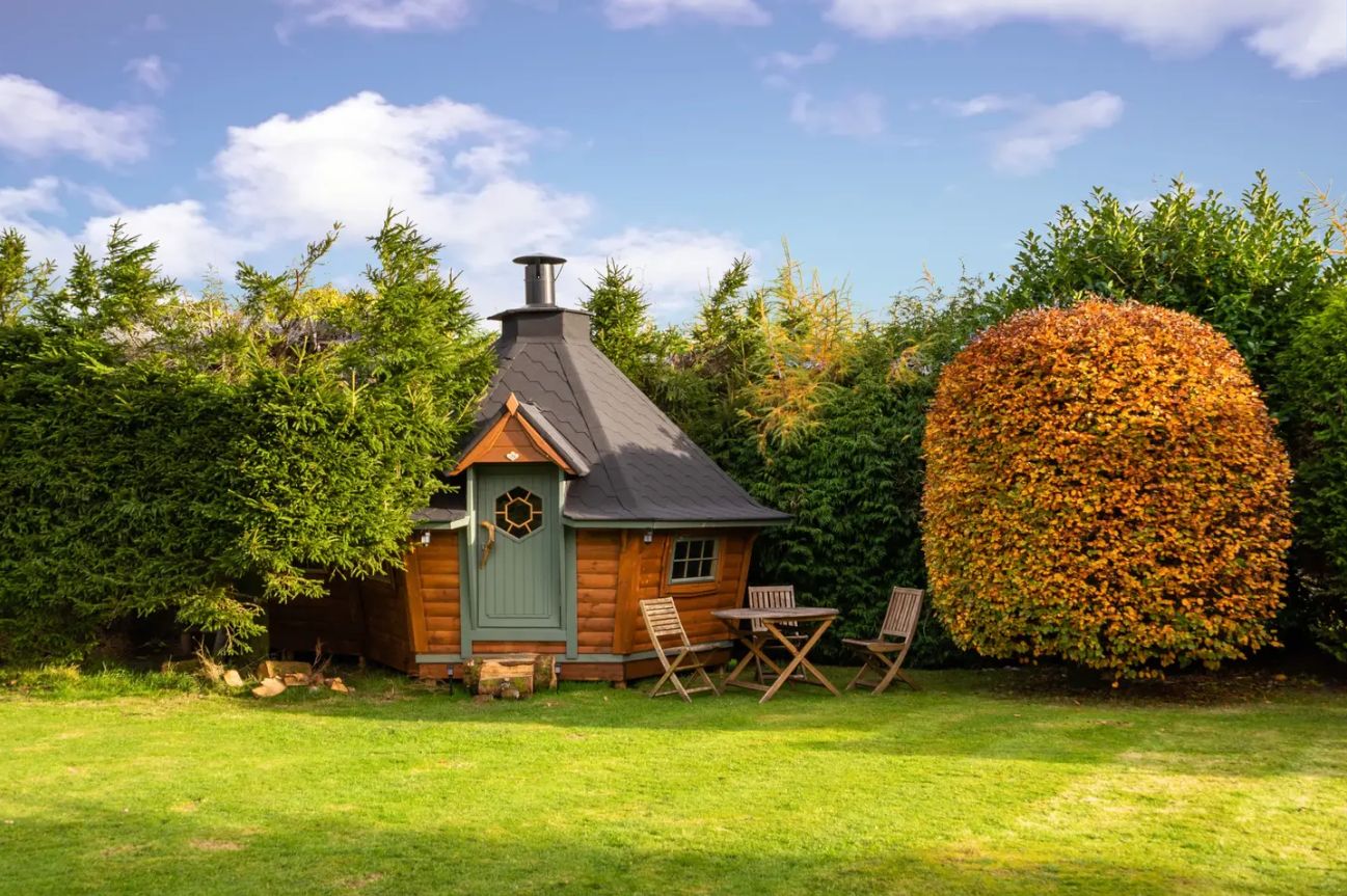 the-den-scandinavian-BBQ-cabin-in-field-on-sunny-day-airbnbs-lake-district
