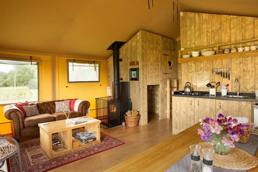 yellow-interior-living-and-kitchen-area-of-tall-trees-safari-tent