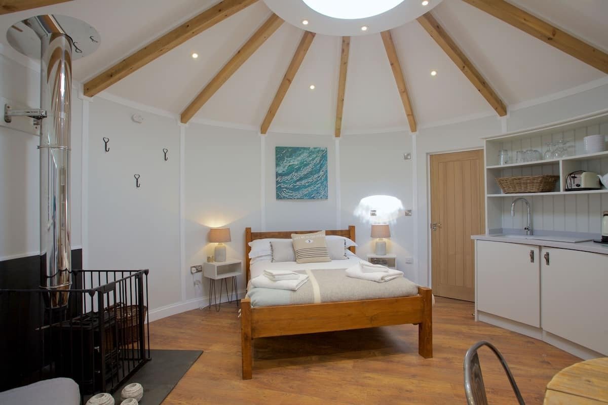 bed-kitchen-and-wood-burner-inside-the-ocean-room-roundhouse