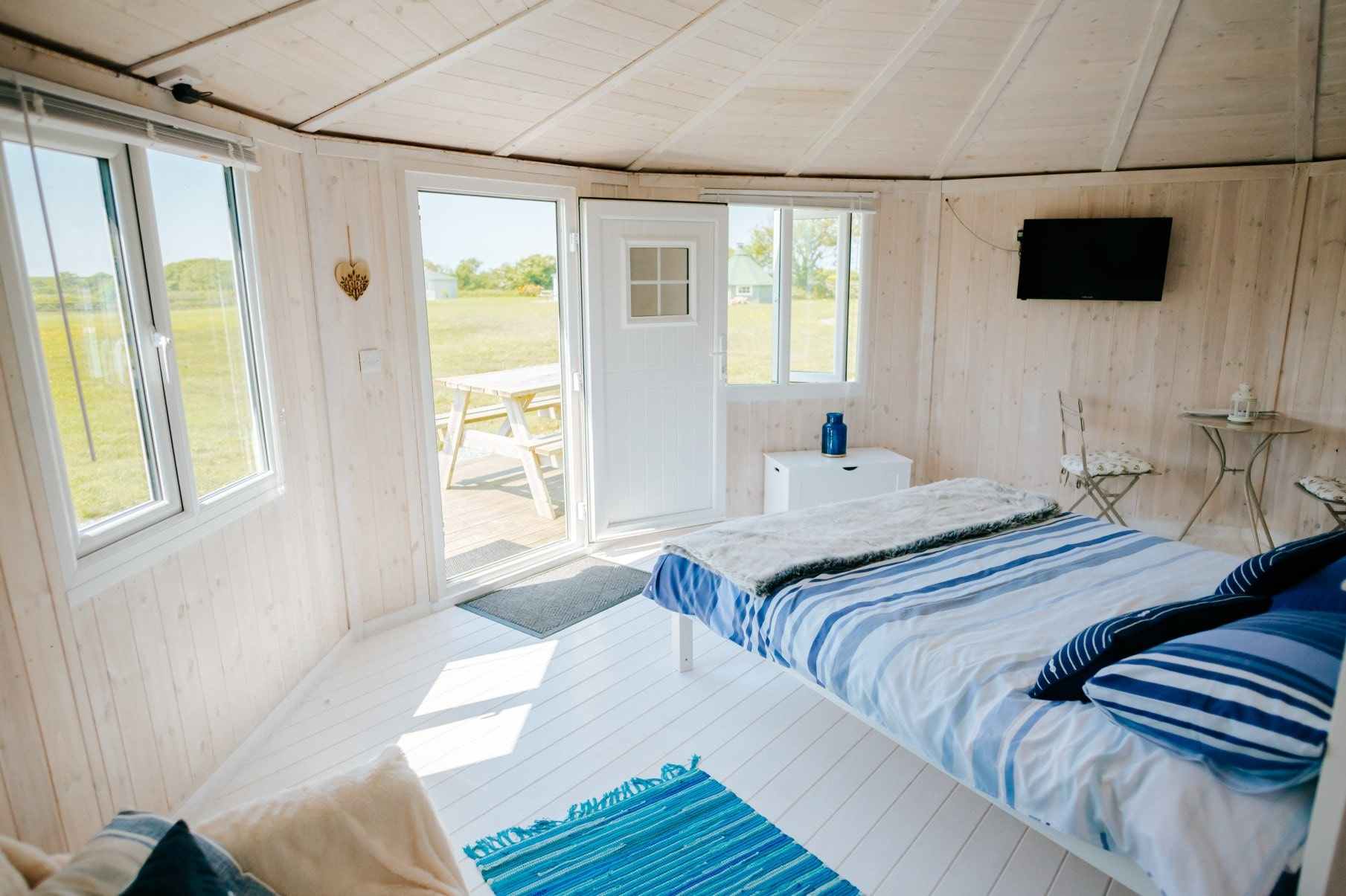 bed-sofa-and-table-inside-welcombe-mouth-cabin-lodges-with-hot-tubs-devon