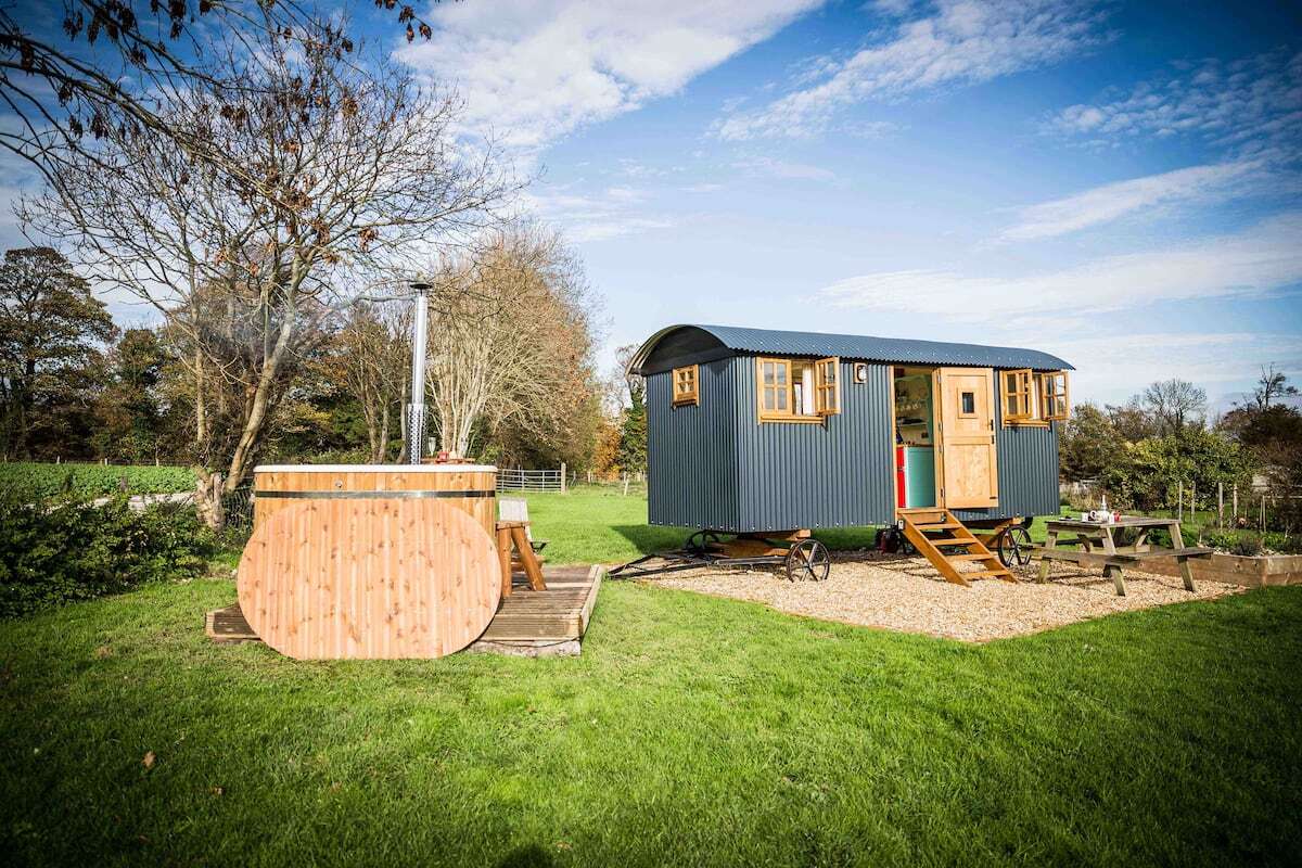 exterior-of-mill-laine-farm-shepherds-hut-with-hot-tub-in-field-glamping-sussex