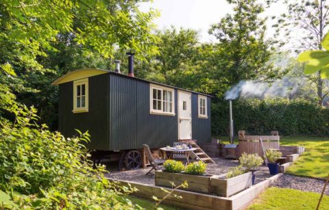 exterior-view-of-meadow-hut-with-hot-tub-and-seating-area-in-lombard-farm-glamping-with-hot-tub-cornwall
