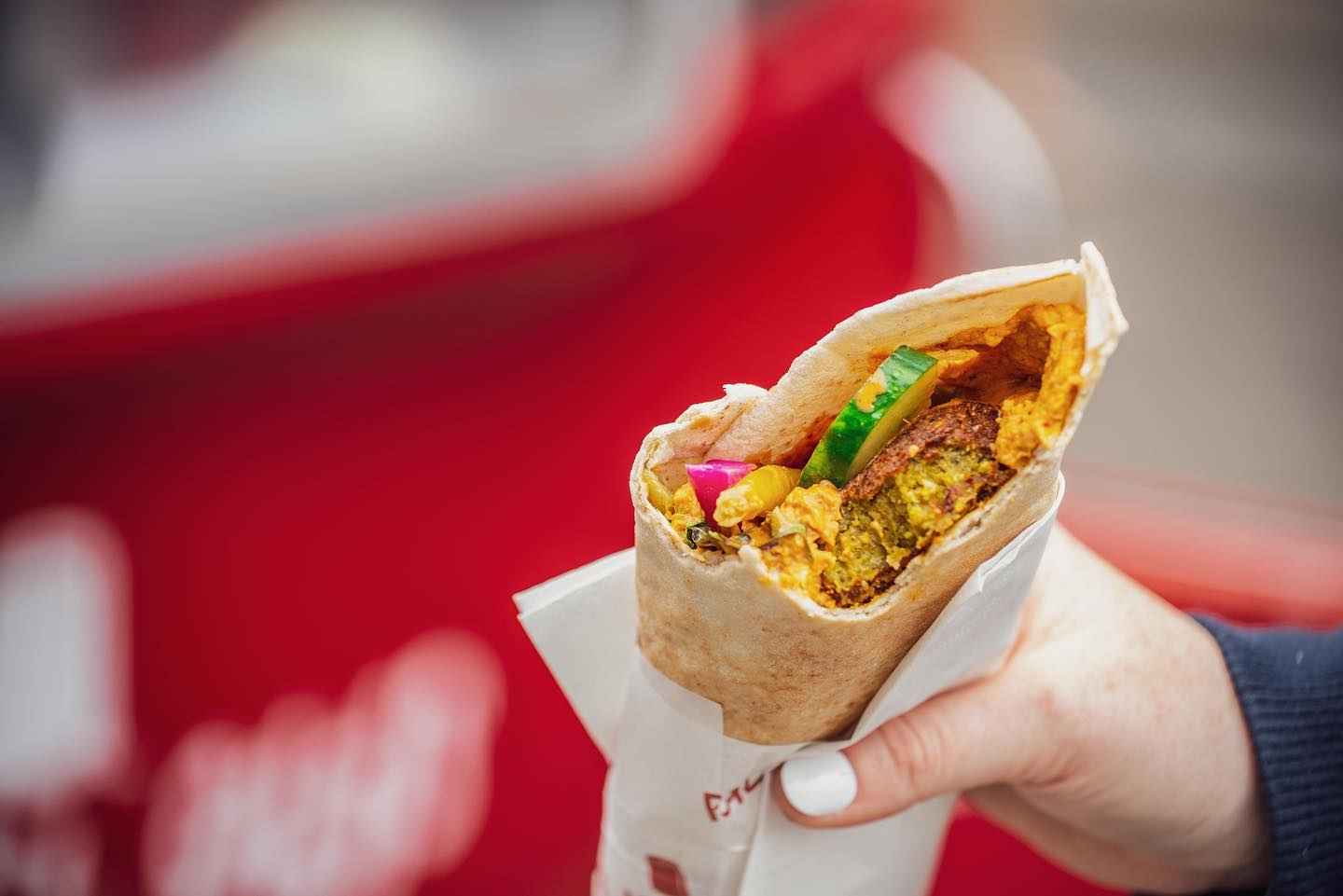 hand-holding-falafel-from-falafel-guys-street-food-van