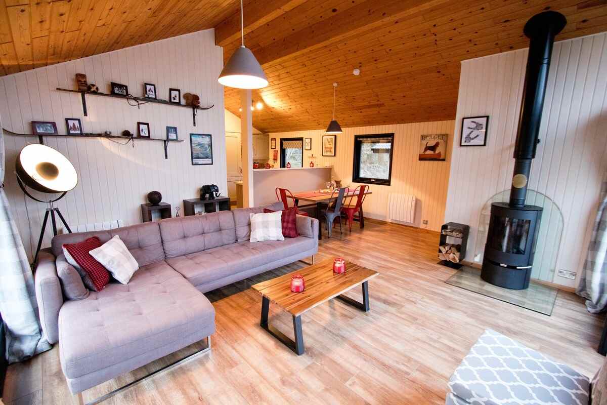 living-space-of-the-drey-lodge-with-sofa-and-woodburner-lodges-with-hot-tubs-northumberland