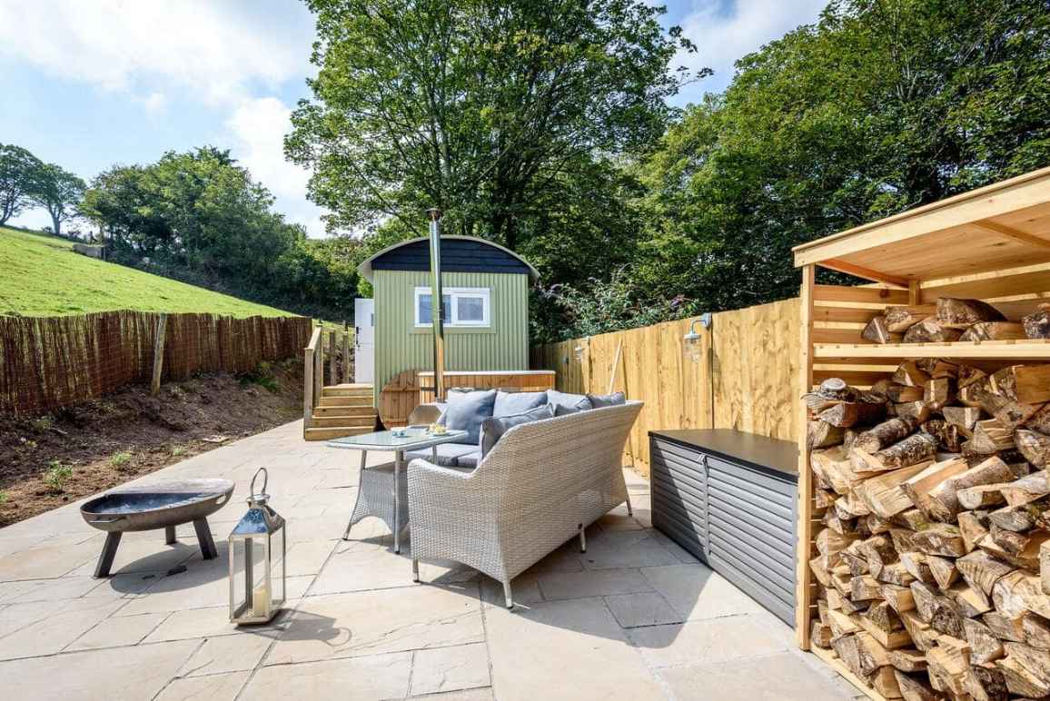 outdoor-seating-area-and-fire-pit-by-green-shepherds-hut-glamping-with-hot-tub-cornwall