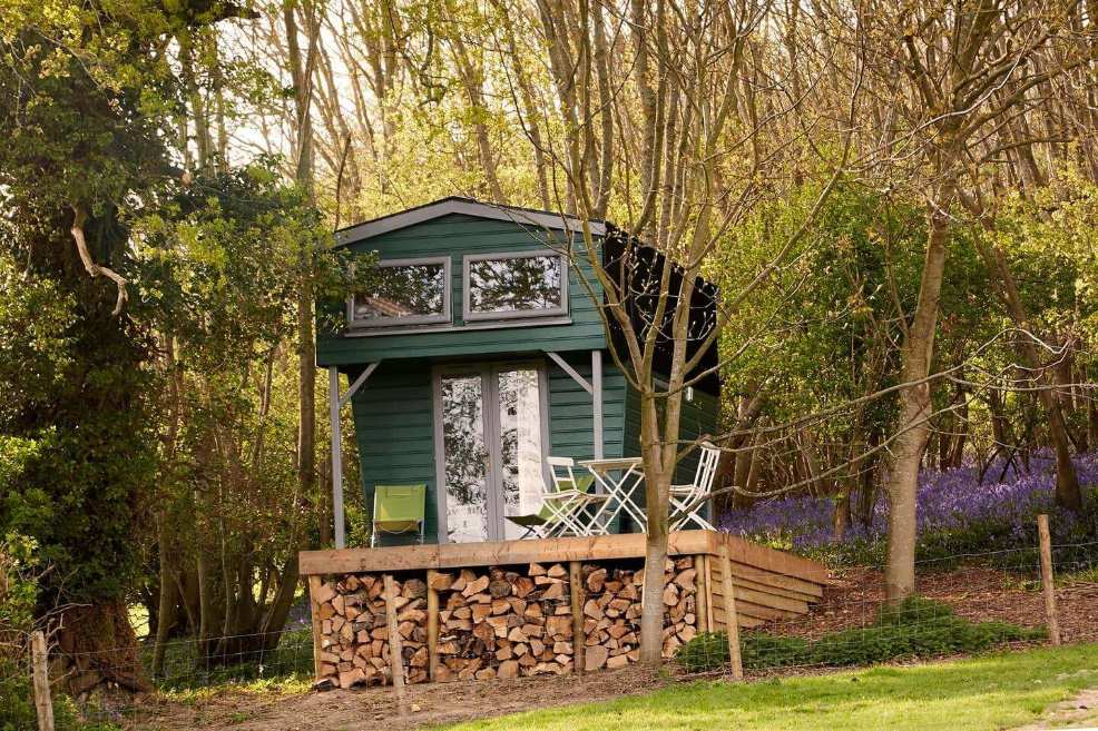 tall-green-the-hut-on-decking-in-forest-glamping-sussex
