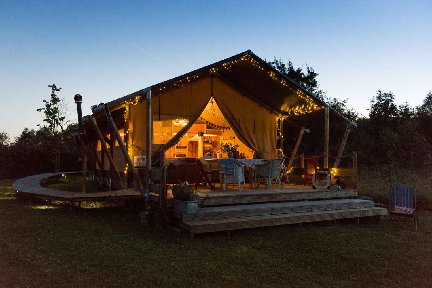 up-sticks-glamping-safari-tent-lit-up-at-night
