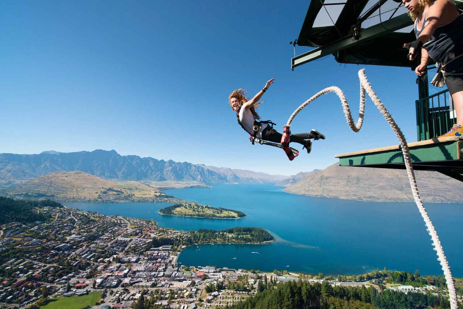 woman-bungee-jumping-from-aj-hackett-ledge-with-lake-in-background