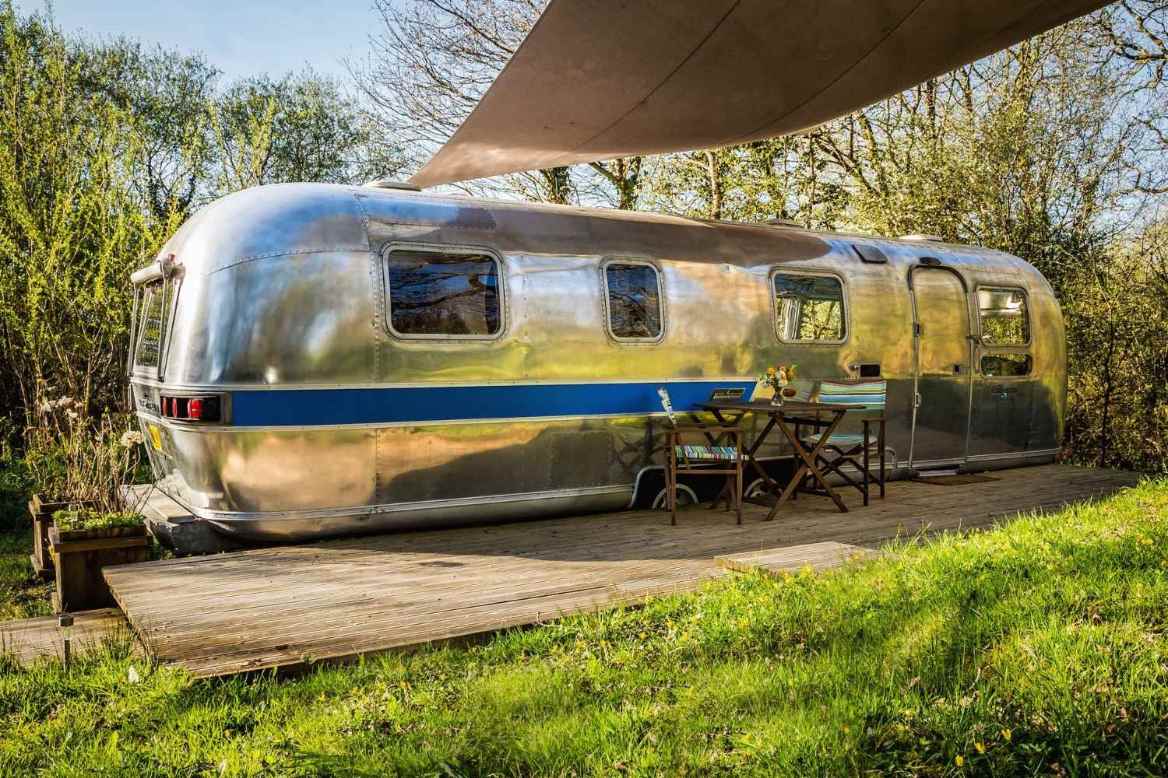 silver-the-76er-airstream-on-decking-with-seating-area