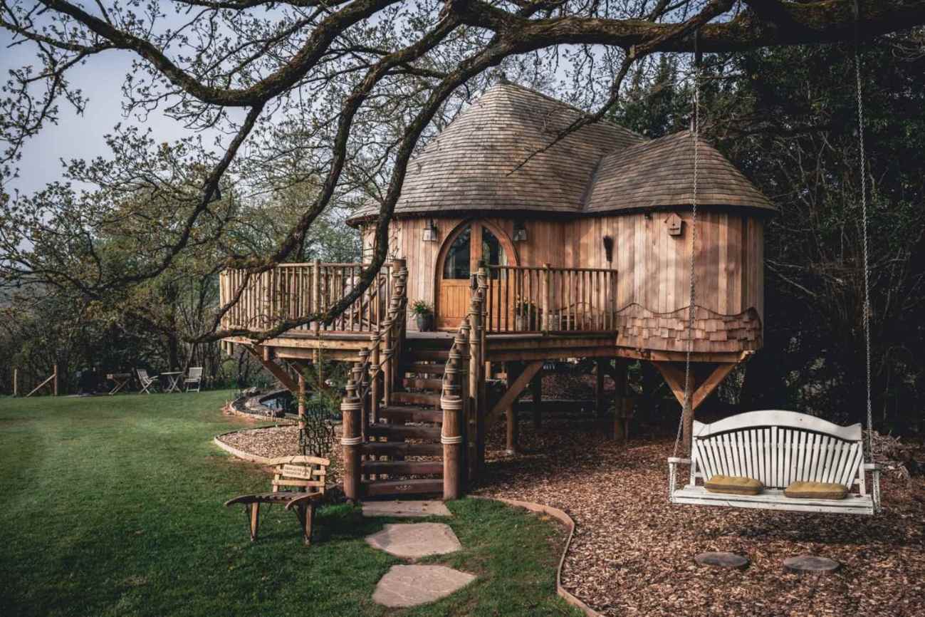 swinging-seat-outside-trewalter-treehouse-in-field-glamping-south-wales