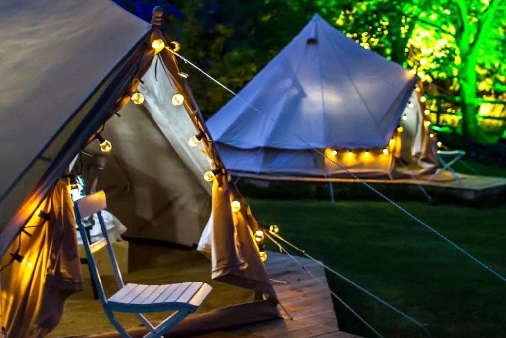two-legan-castle-bell-tents-lit-up-at-night-glamping-kilkenny