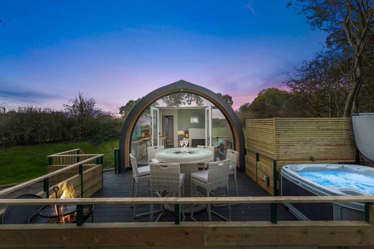 butterfly-house-pod-with-hot-tub-lit-up-at-night-glamping-derbyshire