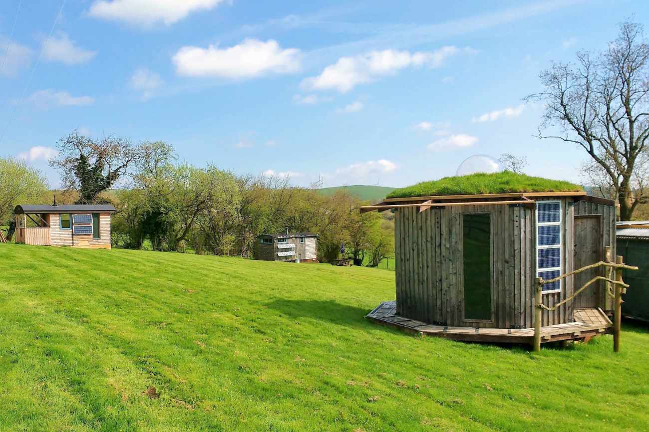 ecopod-holidays-huts-in-field-on-sunny-day