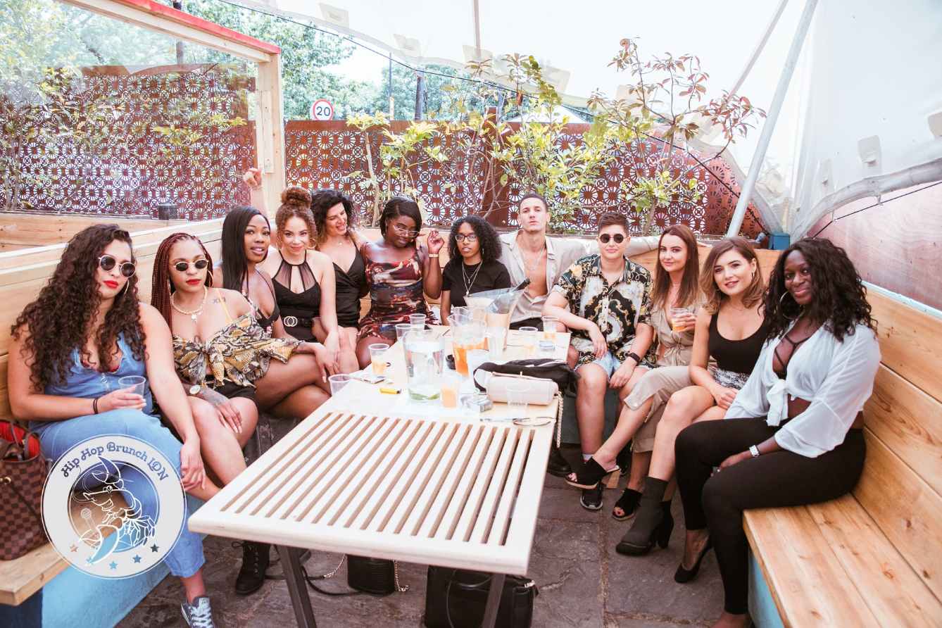 large-group-of-friends-drinking-around-table-at-hip-hop-brunch-bottomless-brunch-brixton