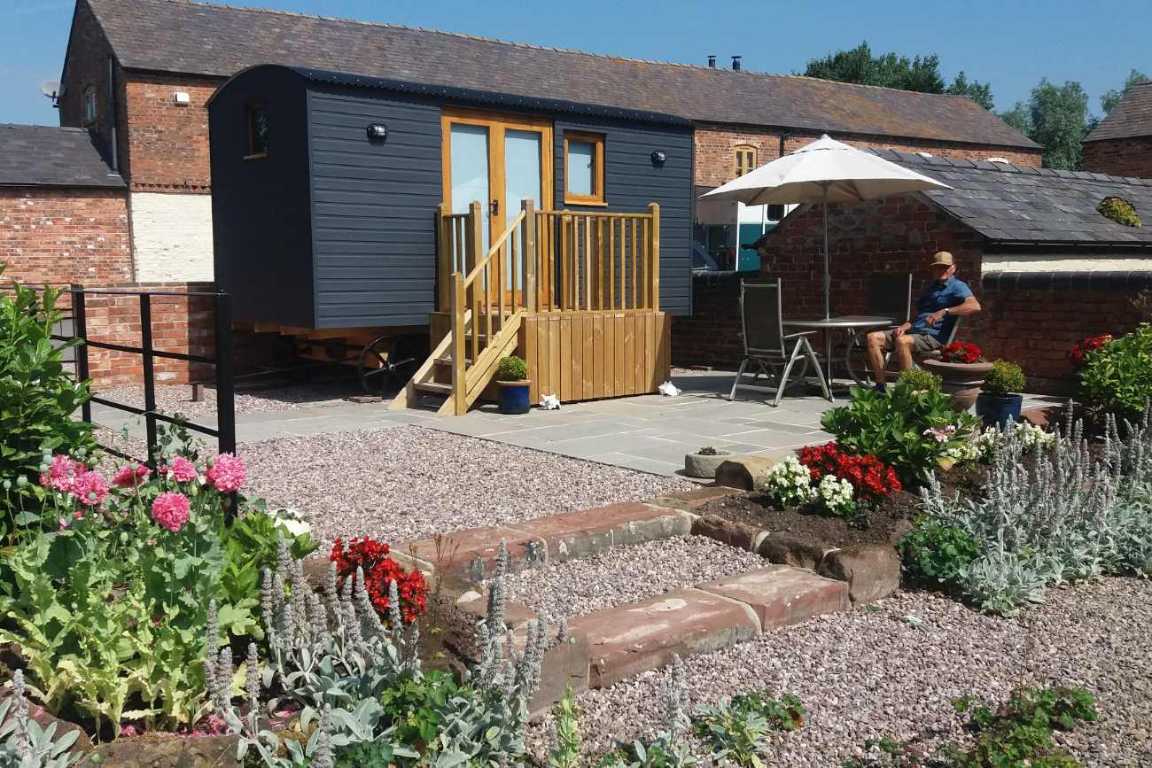 navy-newton-hall-shepherds-hut-with-outdoor-seating